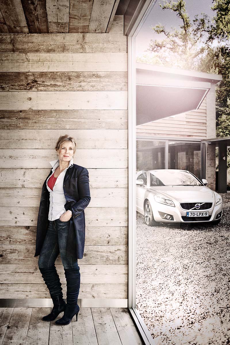 Woman with Volvo C70 in background